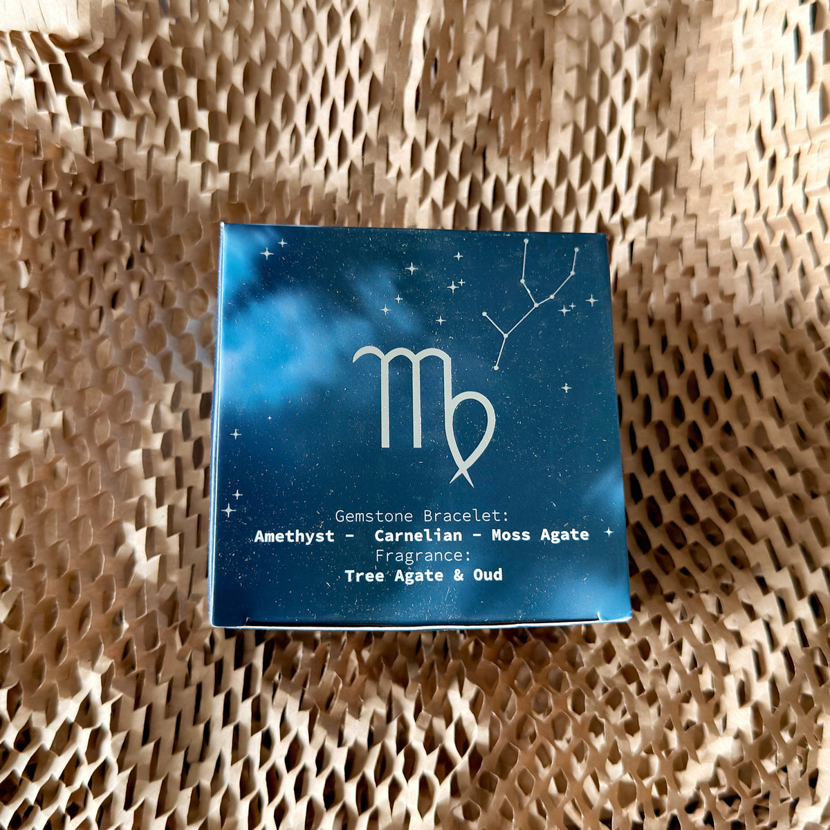 Zodiac candle box cushioned in protective paper packaging
